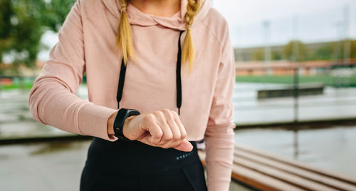 Midsection of woman standing against blurred background