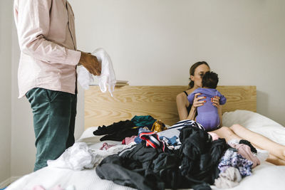 Parents with baby on bed