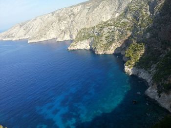 Scenic view of sea and mountains against sky