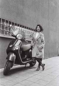 Full length portrait of woman standing outdoors