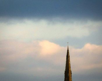 Low angle view of building against cloudy sky