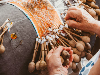 Hands of a woman weaving bobbin lace in a workshop