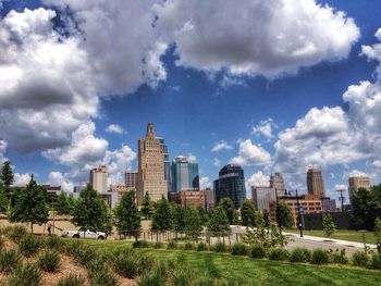 View of cityscape against cloudy sky