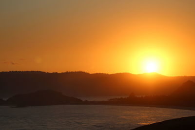 Scenic view of sea against romantic sky at sunset