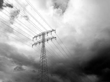 Low angle view of electricity pylon against sky