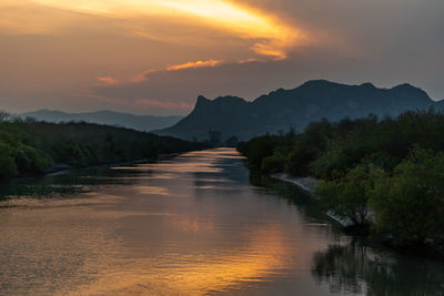 Scenic view of river against sky during sunset