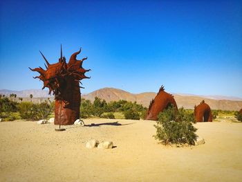 Scenic view of desert against clear blue sky, serpent sculpture, anza borrego 