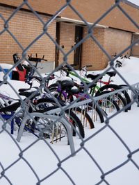 Close-up of bicycles on chainlink fence