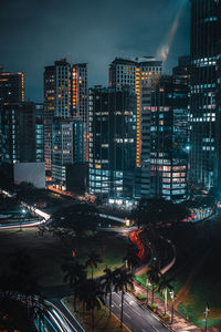 High angle view of illuminated buildings in city at night