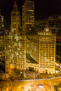 High angle view of illuminated buildings in city at night