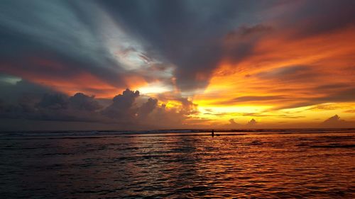 View of dramatic sky over sea during sunset