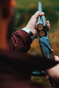 Midsection man holding gun