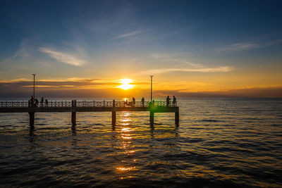 View of sea against cloudy sky during sunset