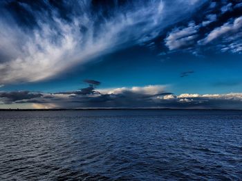 Scenic view of sea against cloudy sky