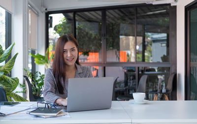 Young woman using laptop on table