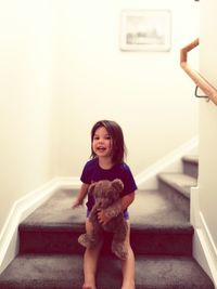 Portrait of happy girl sitting at home