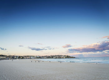 Scenic view of beach against cloudy sky