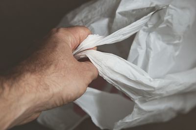 Close-up of hand holding white paper