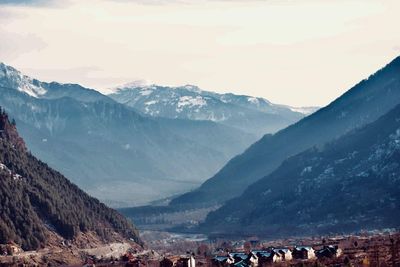 Group of people on mountain range against sky