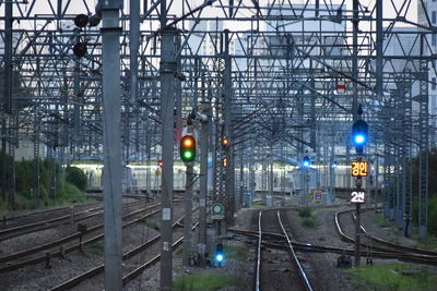 Illuminated railroad tracks against trees