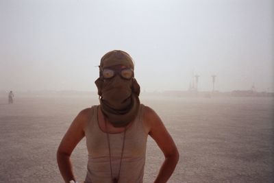 Portrait of man standing on land against sky