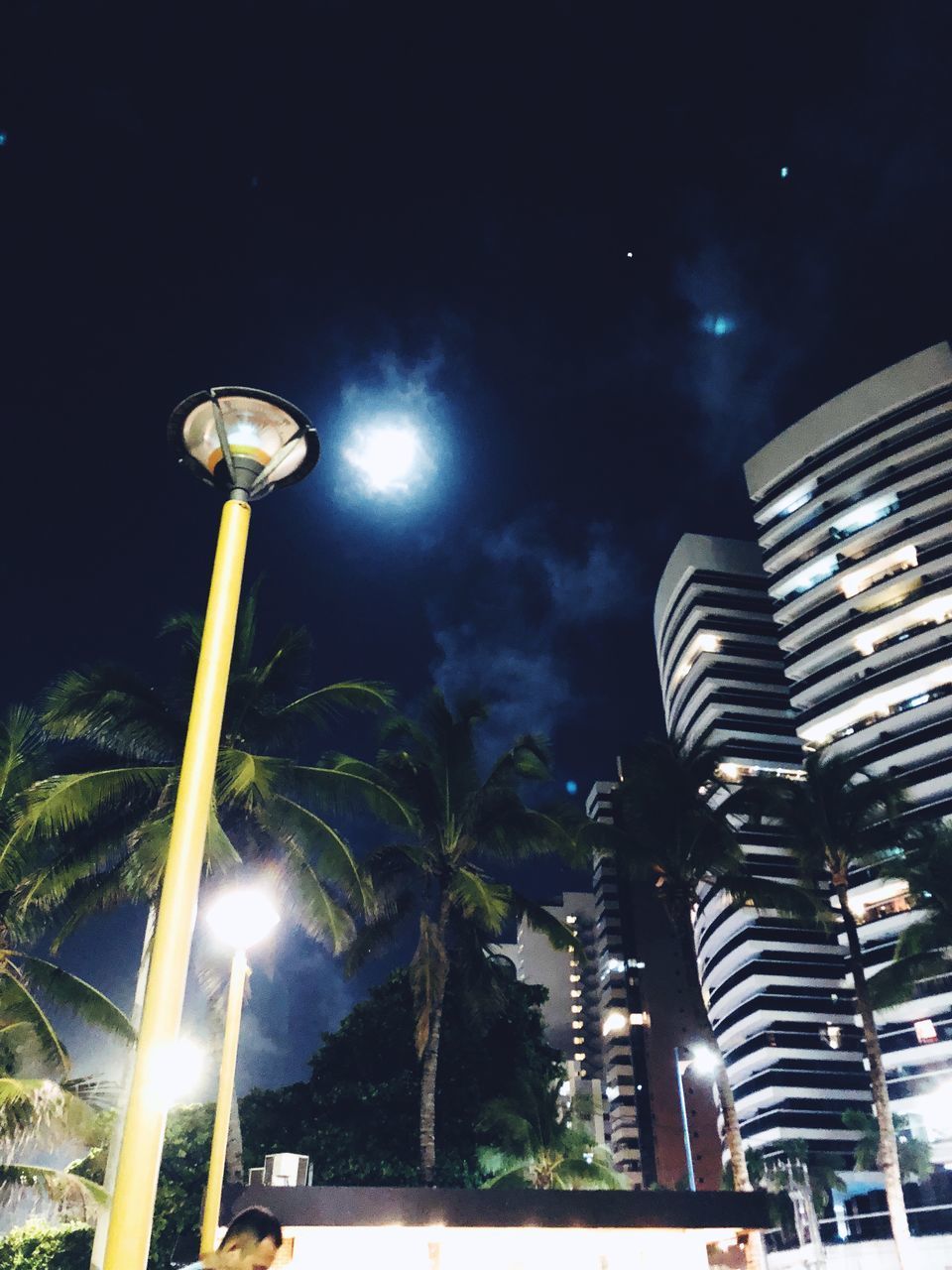 LOW ANGLE VIEW OF ILLUMINATED STREET LIGHT AGAINST SKY AT NIGHT