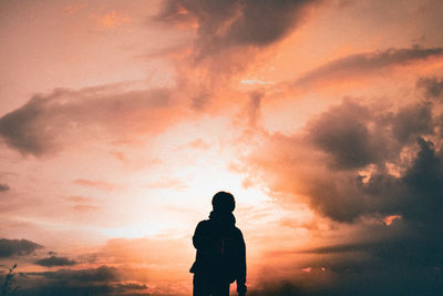 Silhouette man standing against sky