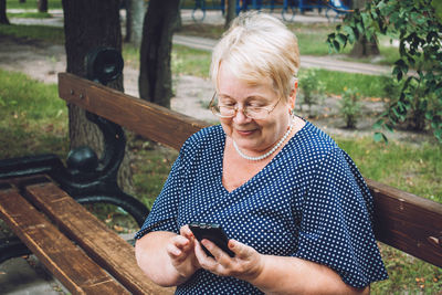 Mid adult woman using mobile phone