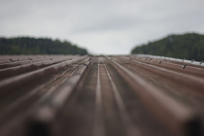 Surface level of railroad tracks against sky