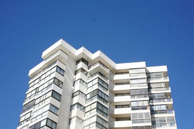 Low angle view of residential building against clear blue sky