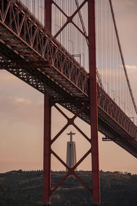 Low angle view of bridge against sky during sunset