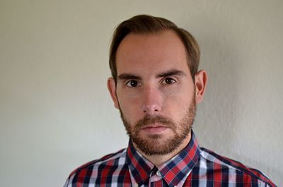 Close-up portrait of man against wall