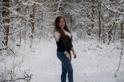 Full length of woman standing on snow covered land