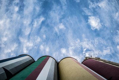 Low angle view of industrial building against blue sky