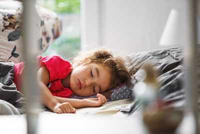 Portrait of boy lying on bed at home