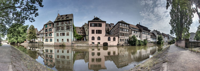 Panoramic view of lake and buildings against sky