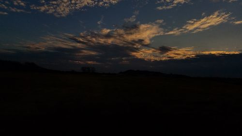 Silhouette landscape against sky during sunset