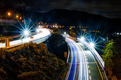 High angle view of light trails on road at night