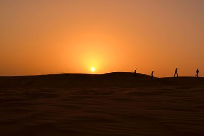 Scenic view of desert against sky during sunset