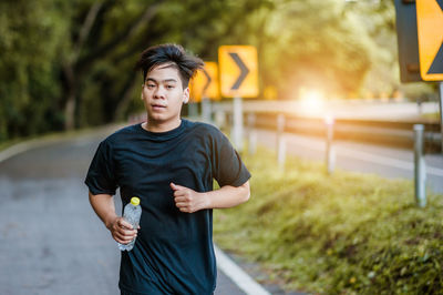 Young athlete running on road