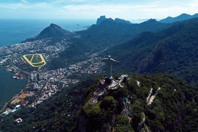 High angle view of city by sea against sky