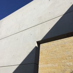 Low angle view of concrete wall at yad vashem during sunny day