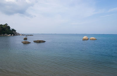 Scenic view of calm sea against cloudy sky