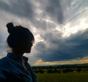 Scenic view of field against cloudy sky