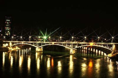 Illuminated bridge over river