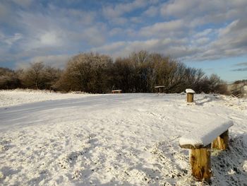 Snow covered field against sky