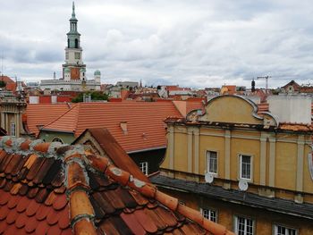 View of cityscape against cloudy sky