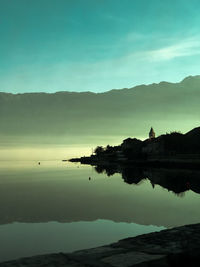 Silhouette mountains by the sea