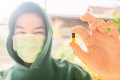 Close-up portrait of man holding hands