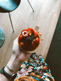 Close-up of hand holding strawberry